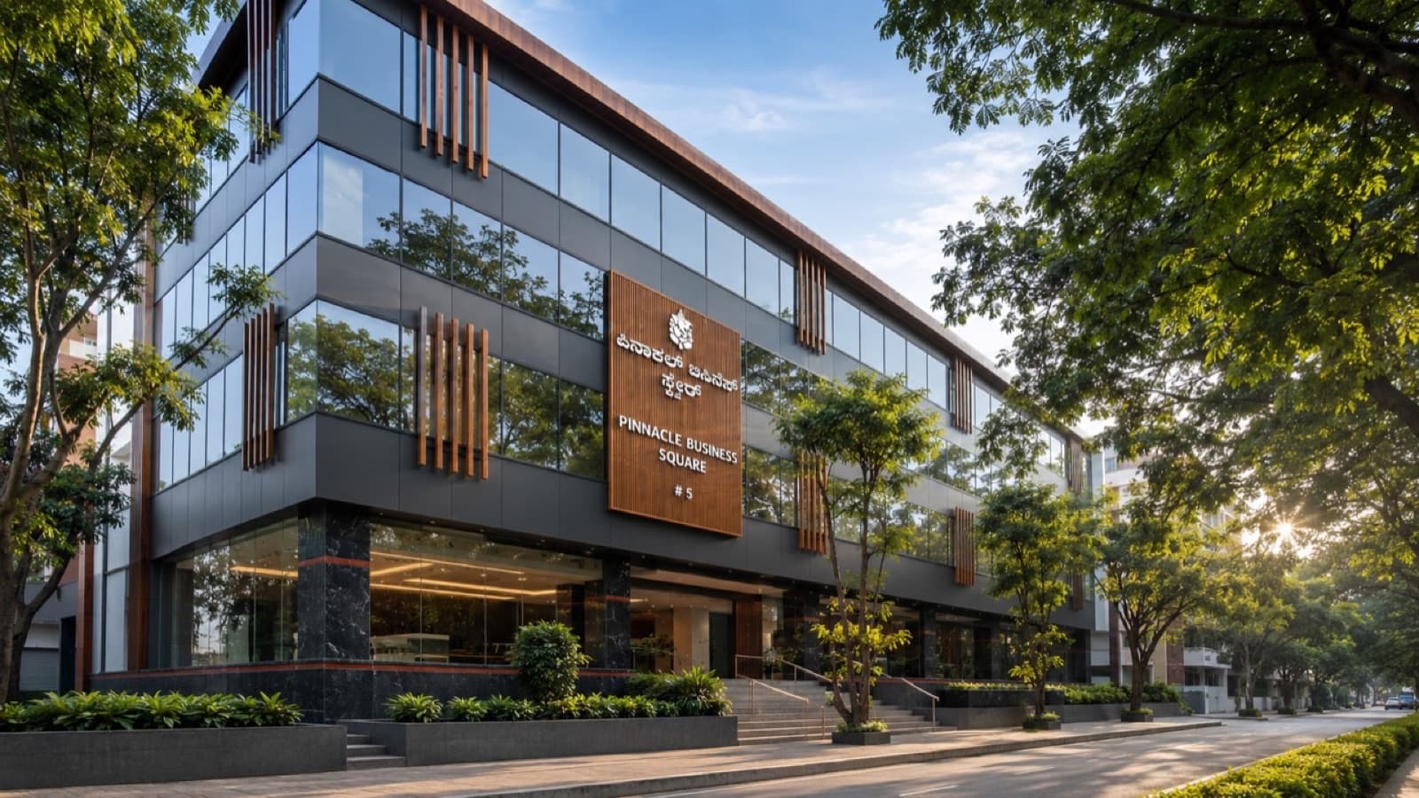 Pinnacle Business Square commercial building with glass frontage and tree-lined street