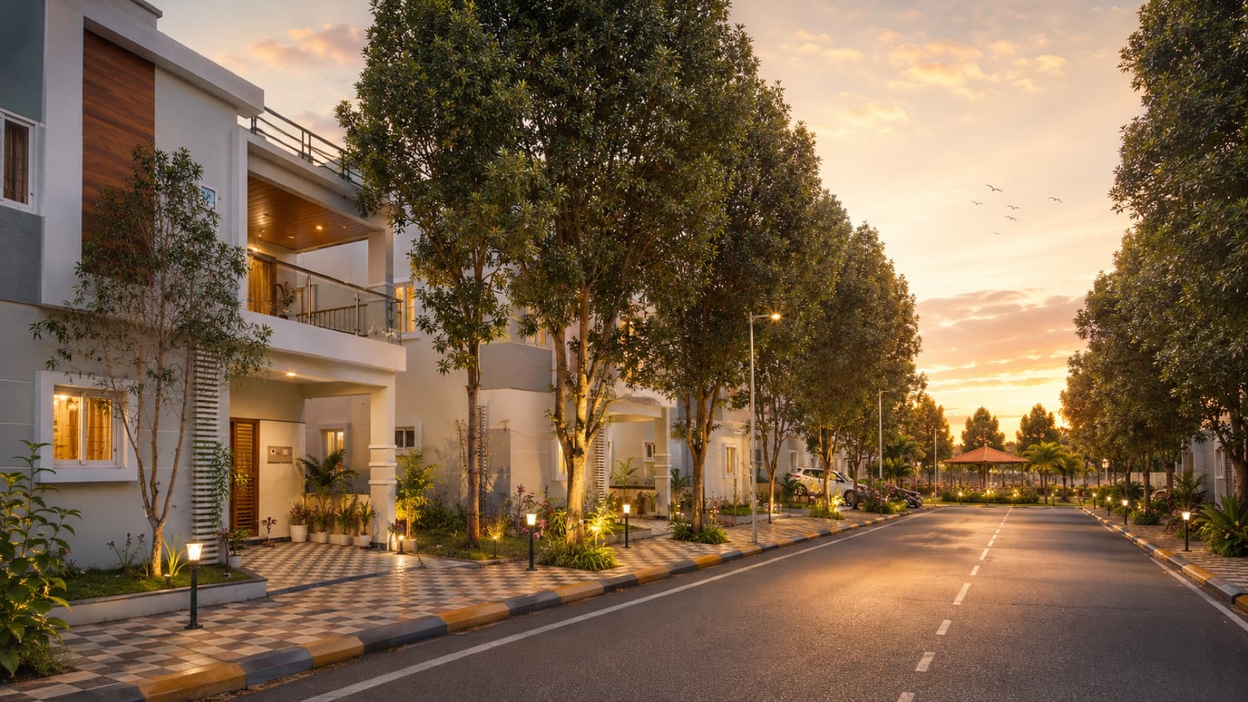 Tree-lined villa community lane with warm evening light and landscaped planting