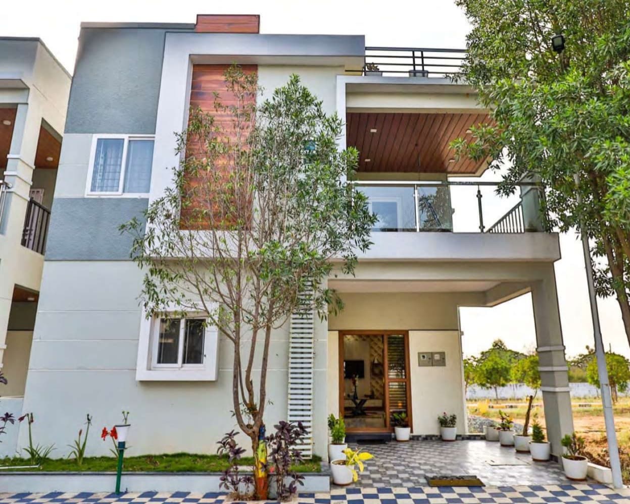 Actual villa facade at Medhyam Serenity Highland with landscaped entry
